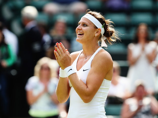  Lucie Safarova of Czech Republic celebrates winning her Ladies' Singles quarter-final match against Ekaterina Makarova of Russia on day eight of the Wimbledon Lawn Tennis Championships at the All England Lawn Tennis and Croquet Club on July 1, 2014