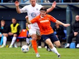 Luke Rooney of Luton Town goes past Matt Paine of Braintree Town during the Skrill Conference Premier match between Luton Town and Braintree Town at Kenilworth Road on April 12, 2014