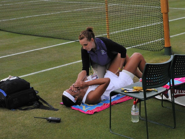 US player Madison Keys receives a medical time out during her women's singles third round match against Kazakhstan's Yaroslava Shvedova on day six of the 2014 Wimbledon Championships at The All England Tennis Club in Wimbledon, southwest London, on June 2