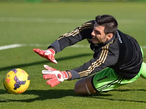 AC Milan's goalkeeper Marco Amelia warms up prior the Italian Serie A football match between Cagliari and AC Milan on January 26, 2014