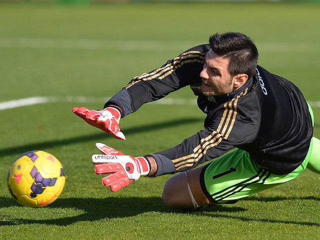 AC Milan's goalkeeper Marco Amelia warms up prior the Italian Serie A football match between Cagliari and AC Milan on January 26, 2014