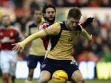 Marius Zaliukas of Leeds United holds off a challenge from Djamal Abdoun of Nottingham Forest during the Sky Bet Championship match between Nottingham Forest and Leeds United at City Ground on December 29, 2013
