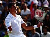 Milos Raonic of Canada celebrates winning his Gentlemen's Singles fourth round match against Kei Nishikori of Japan on day eight of the Wimbledon Lawn Tennis Championships at the All England Lawn Tennis and Croquet Club on July 1, 2014
