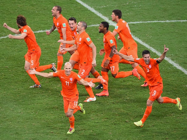 Netherlands players celebrate after defeating Costa Rica in a penalty shootout during the 2014 FIFA World Cup Brazil Quarter Final match between the Netherlands and Costa Rica at Arena Fonte Nova on July 5, 2014