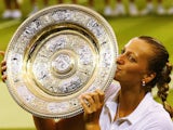 Czech tennis player Petra Kvitova lifts the Venus Rosewater Dish after winning Wimbledon on July 5, 2014