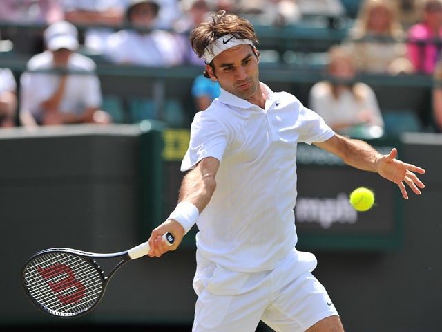 Switzerland's Roger Federer returns against Spain's Tommy Robredo during their men's singles fourth round match on day eight of the 2014 Wimbledon Championships at The All England Tennis Club in Wimbledon, southwest London, on July 1, 2014