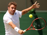 Switzerland's Stanislas Wawrinka returns to Spain's Feliciano Lopez during their men's singles fourth round match on day eight of the 2014 Wimbledon Championships at The All England Tennis Club in Wimbledon, southwest London, on July 1, 2014