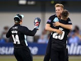 Matthew Dunn of Surrey celebrates with Jason Roy and Gary Wilson after taking the wicket of Essex's Mark Pettini during the Natwest T20 Blast match between Essex Eagles and Surrey at Chelmsford County Cricket Ground on July 04, 2014
