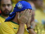 Brazilian fan react during the semi-final football match between Brazil and Germany at The Mineirao Stadium in Belo Horizonte during the 2014 FIFA World Cup on July 8, 2014