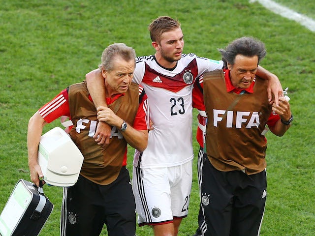 Christoph Kramer of Germany is helped off the field by trainers during the 2014 FIFA World Cup Brazil Final match between Germany and Argentina at Maracana on July 13, 2014