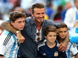 Former England international David Beckham and sons Brooklyn Beckham (L), Cruz Beckham (2nd R) and Romeo Beckham (R) prior to the 2014 FIFA World Cup final on July 13, 2014