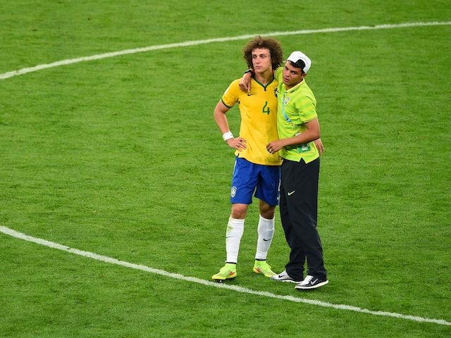Thiago Silva consoles fellow Brazilian defender David Luiz after the semi-final World Cup exit to Germany on July 8, 2014