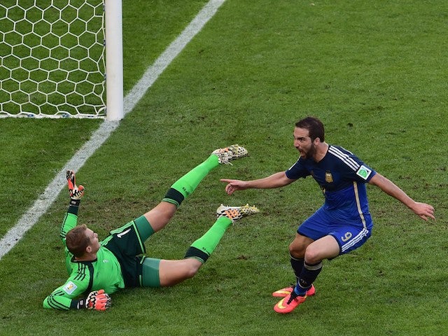Argentina's forward Gonzalo Higuain (R) shoots and scores past Germany's goalkeeper Manuel Neuer a disallowed goal during the 2014 FIFA World Cup final football match on July 13, 2014