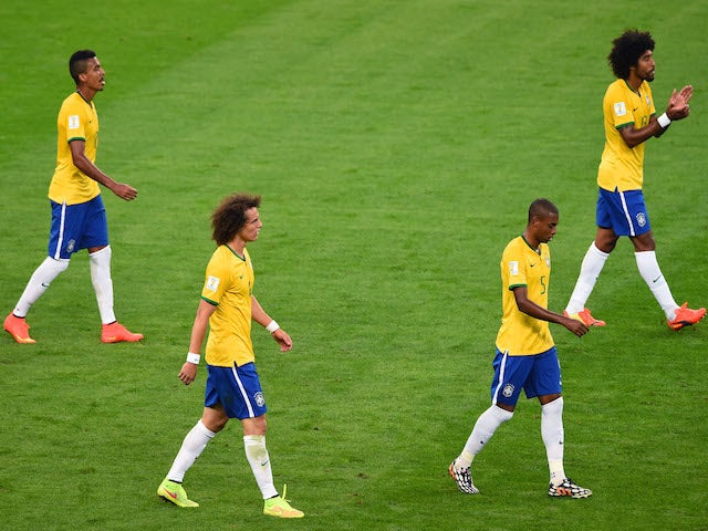 Luiz Gustavo, David Luiz, Fernandinho and Dante of Brazil look dejected after a goal during the 2014 FIFA World Cup Brazil Semi Final match on July 8, 2014