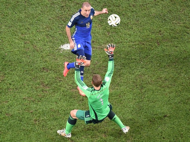 Germany's goalkeeper Manuel Neuer (FRONT) prepares to make a save from Argentina's forward Rodrigo Palacio during the final football match o