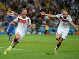 Mario Goetze of Germany (L) celebrates scoring his team's first goal with Thomas Mueller during the 2014 FIFA World Cup Brazil Final match on July 13, 2014