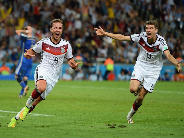 Mario Goetze of Germany (L) celebrates scoring his team's first goal with Thomas Mueller during the 2014 FIFA World Cup Brazil Final match on July 13, 2014