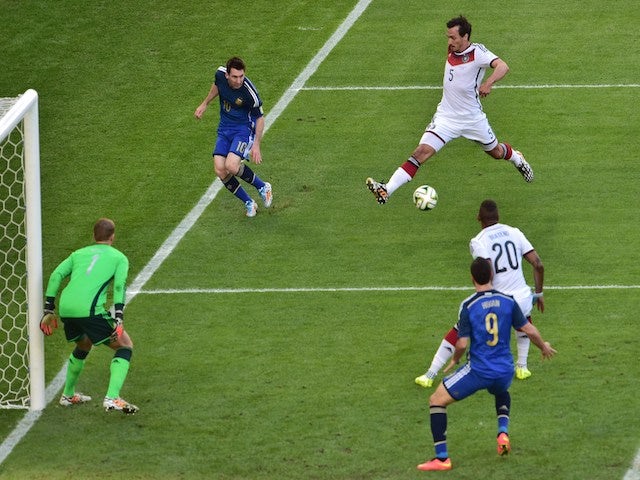 Germany's defender Mats Hummels (R) blocks a ball to Argentina's forward and captain Lionel Messi (R) during the 2014 FIFA World Cup final on July 13, 2014
