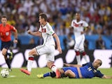 Germany's forward Miroslav Klose (2R) is fouled by Argentina's midfielder Javier Mascherano, resulting in a yellow card, during the second half of the 2014 FIFA World Cup final  on July 13, 2014
