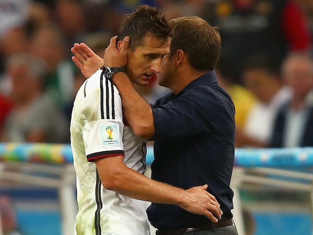 Assistant coach Hansi Flick hugs Miroslav Klose of Germany as he exits the game during the 2014 FIFA World Cup Brazil Final match on July 13, 2014