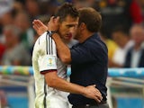Assistant coach Hansi Flick hugs Miroslav Klose of Germany as he exits the game during the 2014 FIFA World Cup Brazil Final match on July 13, 2014
