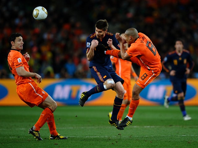 Nigel De Jong of the Netherlands tackles Xabi Alonso of Spain during the 2010 FIFA World Cup South Africa Final match between Netherlands and Spain at Soccer City Stadium on July 11, 2010