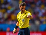 Referee Nicola Rizzoli gestures during the 2014 FIFA World Cup Brazil Quarter Final match between Argentina and Belgium at Estadio Nacional on July 5, 2014