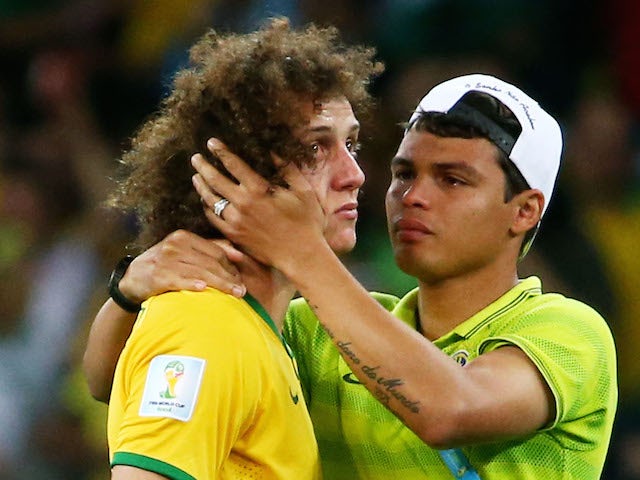 Thiago Silva of Brazil (R) consoles teammate David Luiz after Germany's 7-1 victory during the 2014 FIFA World Cup Brazil Semi Final match on July 8, 2014