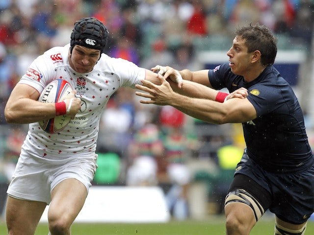 England's Tom Powell (L) vies with Argentina's Nicolas Coronel during the Rugby Union England Sevens Cup at Twickenham Stadium, southwest London, on May 10, 2014