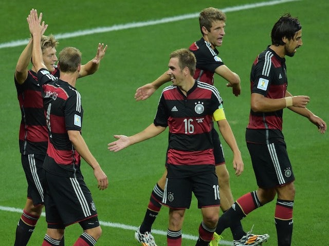 Germany's players celebrate after midfielder Toni Kroos scored his team's third goal during the semi-final football match against Brazil on July 8, 2014