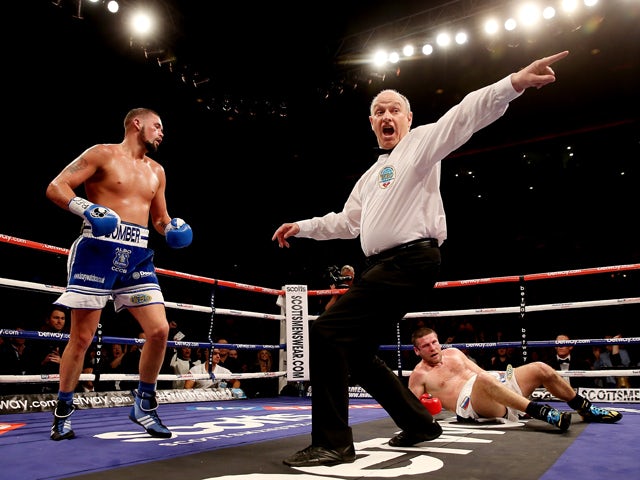 Tony Bellew of Great Britain knocks down Valery Brudov of Russia during their Vacant WBO International Cruiserweight bout at Liverpool Echo Arena on March 15, 2014
