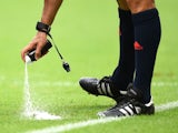Referee Carlos Velasco Carballo sprays a temporary line during the 2014 FIFA World Cup Brazil Group F match between Bosnia and Herzegovina and Iran on June 25, 2014