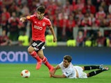 Andre Gomes of Benfica evades the challenge from Daniel Carrico of Sevilla during the UEFA Europa League Final match between Sevilla FC and SL Benfica at Juventus Stadium on May 14, 2014