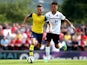 Aaron Ramsey of Arsenal tackles with Lee Angol of Boreham Wood during the pre season friendly match between Borehamwood and Arsenal at Meadow Park on July 19, 2014