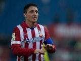 Cristian Rodriguez of Atletico de Madrid jokes with Atletico de Madrid fans playing Uruguayan Kettledrums after the Copa del Rey Round of 32 second leg match between Club Atletico de Madrid and Sant Andreu at Vivente Calderon Stadium on December 18, 2013