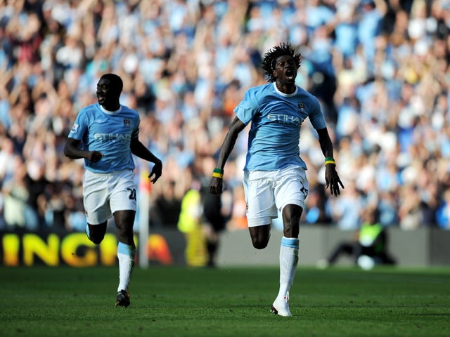 Emmanuel Adebayor of Manchester City runs towards the Arsenal fans as he celebrates scoring with team-mate Kolo Toure during the Barclays Premier League match between Manchester City and Arsenal at the City of Manchester Stadium on September 12, 2009