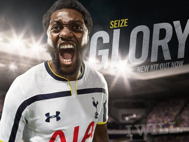 Emmanuel Adebayor models the Spurs 2014-15 home kit