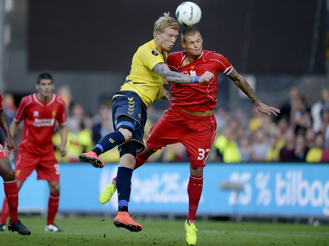 Simon Makienok of Brondby vies with Martin Skrtel of Liverpool on July 16, 2014