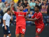 Suso of Liverpool celebrates scoring with team mate Jordan Ibe during the pre season friendly match between Preston North End and Liverpool at Deepdale on July 19, 2014
