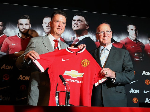 Manchester United's newly-appointed Dutch manager Louis van Gaal poses for pictures with retired English footballer Sir Bobby Charlton during a photocall at Old Trafford in Manchester, north-west England on July 17, 2014