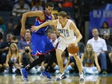  Michael Carter-Williams #1 of the Philadelphia 76ers tries to steal the ball from Luke Ridnour #13 of the Charlotte Bobcats during their game at Time Warner Cable Arena on April 12, 2014
