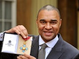 Paul Elliott holds his Commander of the British Empire (CBE) medal, after it was presented to him by the Prince of Wales during an Investiture Ceremony at Buckingham Palace on February 1, 2013
