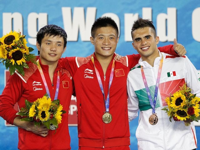 Medallists Qiu Bo, Yang Jian and Ivan Garcia after the men's 10m platform final at the FINA World Cup on July 20, 2014