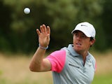 Rory McIlroy of Northern Ireland reaches for a golf ball on the practice ground during the final round of The 143rd Open Championship at Royal Liverpool on July 20, 2014 in Hoylake, England