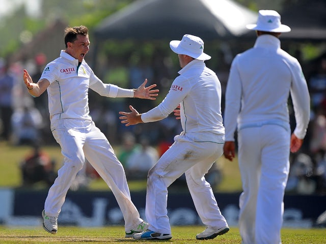 South Africa cricketer Dale Steyn celebrates with teammates after he dismissed Sri Lankan batsman Lahiru Thirimanne during the third day of the opening Test match between Sri Lanka and South Africa at the Galle International Cricket Stadium in Galle on Ju