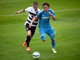 Billy Jones of Sunderland is challenged by Adam Mitchell of Darlington during a pre-season friendly match between Darlington and Sunderland at Heritage Park on July 19, 2014