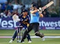 Luke Wright of Sussex hits out while Mark Wallace of Glamorgan looks on during the Natwest T20 Blast match between Sussex Sharks and Glamorgan at The BrightonAndHoveJobs.com County Ground on July 15, 2014