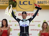 Germany's Tony Martin celebrates his combativity prize on the podium at the end of the 161.50 km tenth stage of the 101st edition of the Tour de France cycling race on July 14, 2014