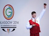Gold medallist Adam Peaty of England celebrates during the medal ceremony for the Men's 100m Breaststroke Final at Tollcross International Swimming Centre during day three of the Glasgow 2014 Commonwealth Games on July 26, 2014