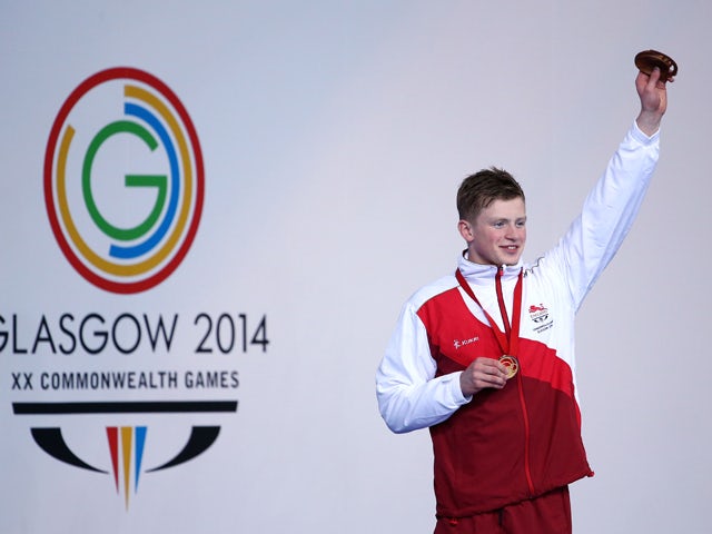 Gold medallist Adam Peaty of England celebrates during the medal ceremony for the Men's 100m Breaststroke Final at Tollcross International Swimming Centre during day three of the Glasgow 2014 Commonwealth Games on July 26, 2014